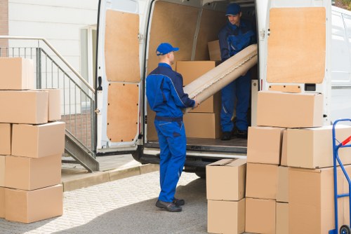 Man with van loading furniture for a removal job in Whitton