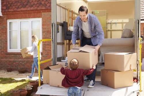 Removal company van and moving crew in a Whitton residential street